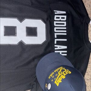 Men’s lot of 2 “Abdullah” jersey (raiders) & “Cry Baby” voodoo child hat